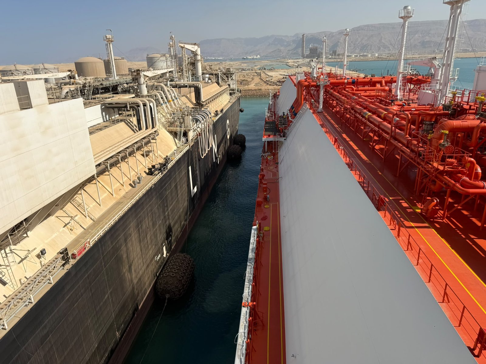 LNG carrier moored close alongside the FSRU with pneumatic fenders during the STS operation at Ain Sokhna
