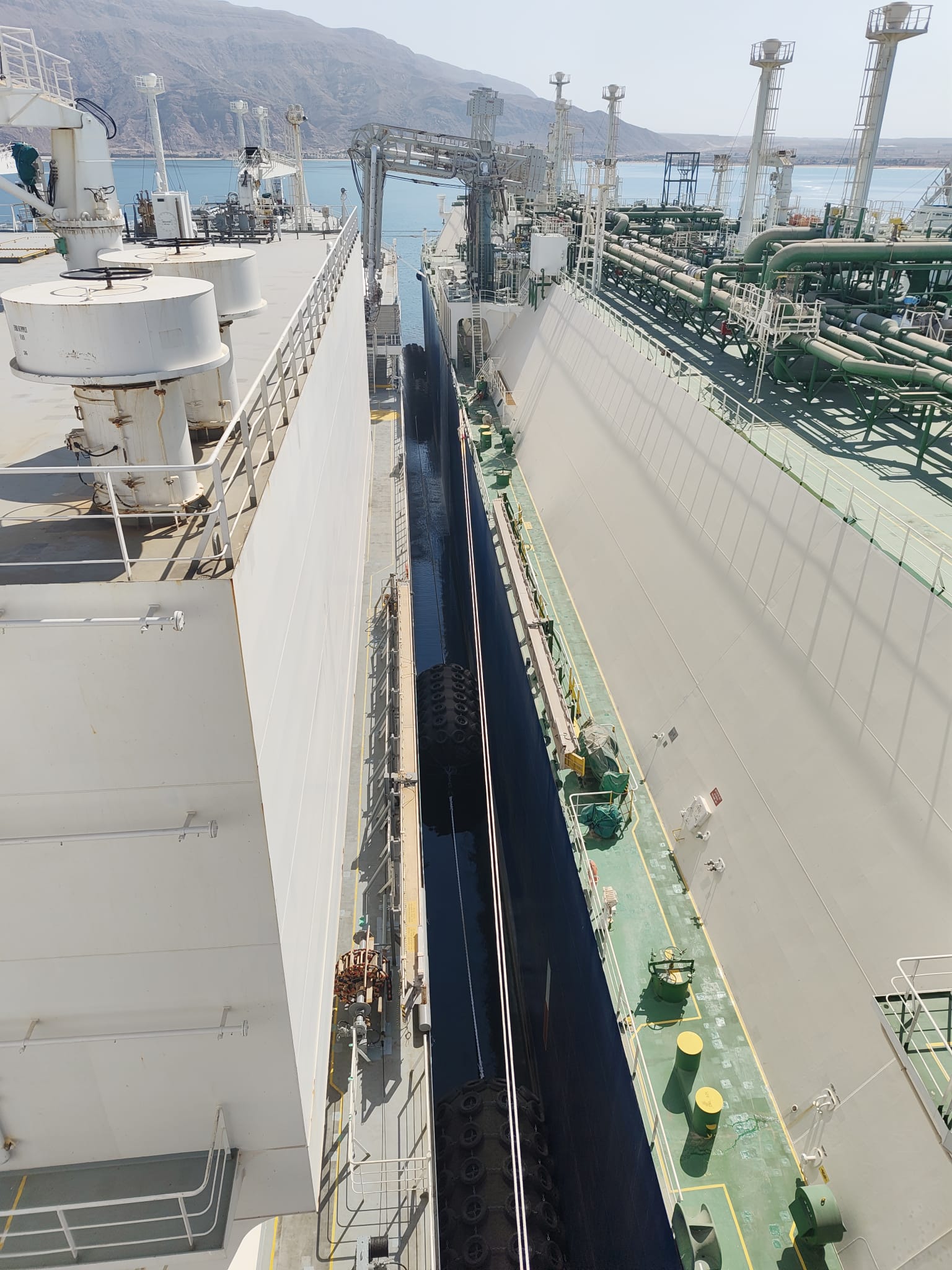 LNG carrier and FSRU moored close alongside with pneumatic fenders during the ship-to-ship transfer at Ain Sukhna, Egypt