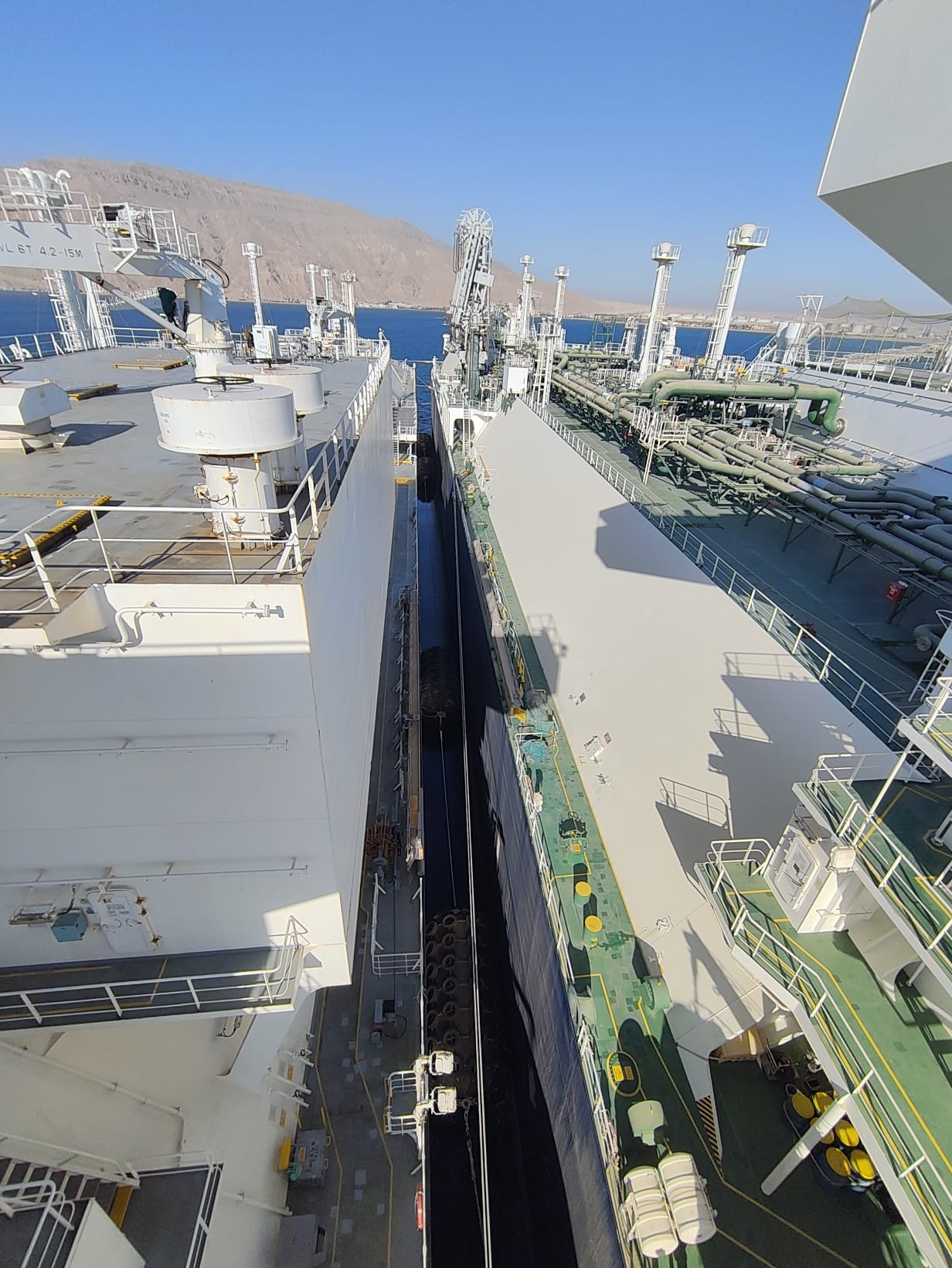 LNG carrier alongside the FSRU under clear skies on the Gulf of Suez at Ain Sukhna