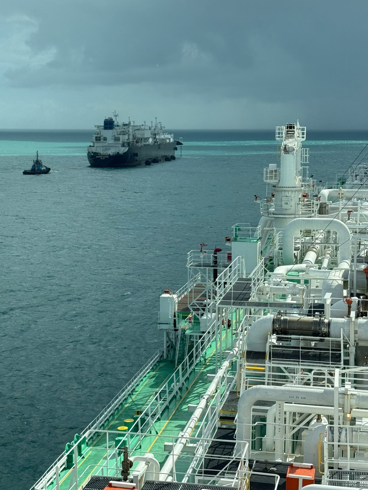 LNG carrier under tug escort approaching for the transfer off Sergipe, Brasil